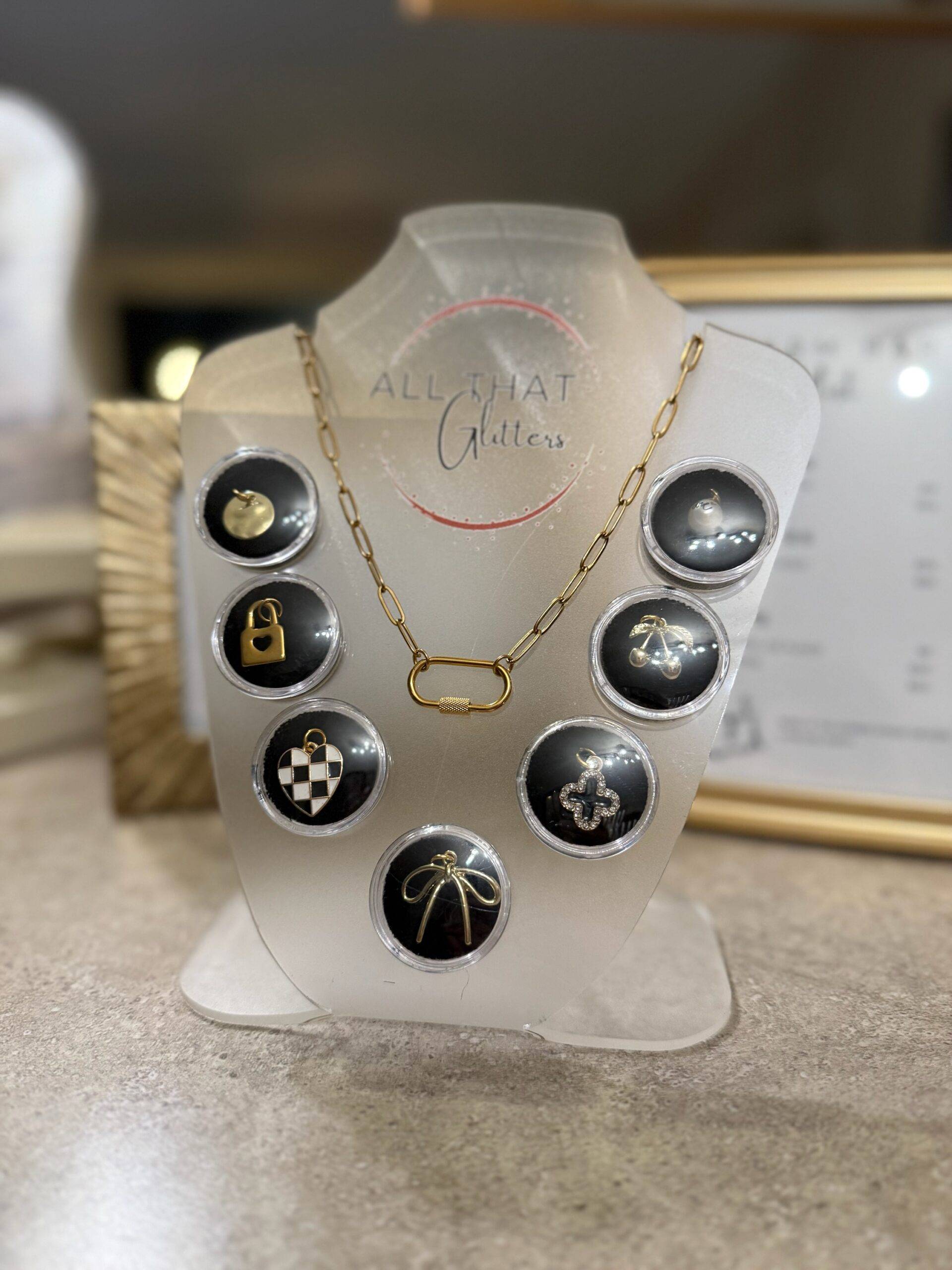 Charm necklace with charms on an All That Glitters display