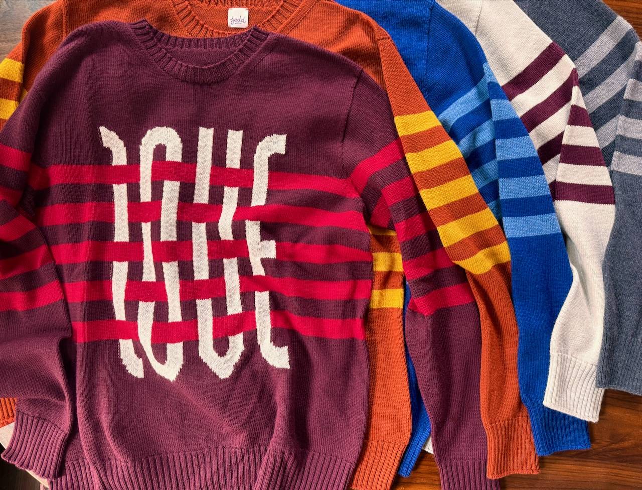 A collection of striped sweaters with the word LOVE interwoven in the design.
