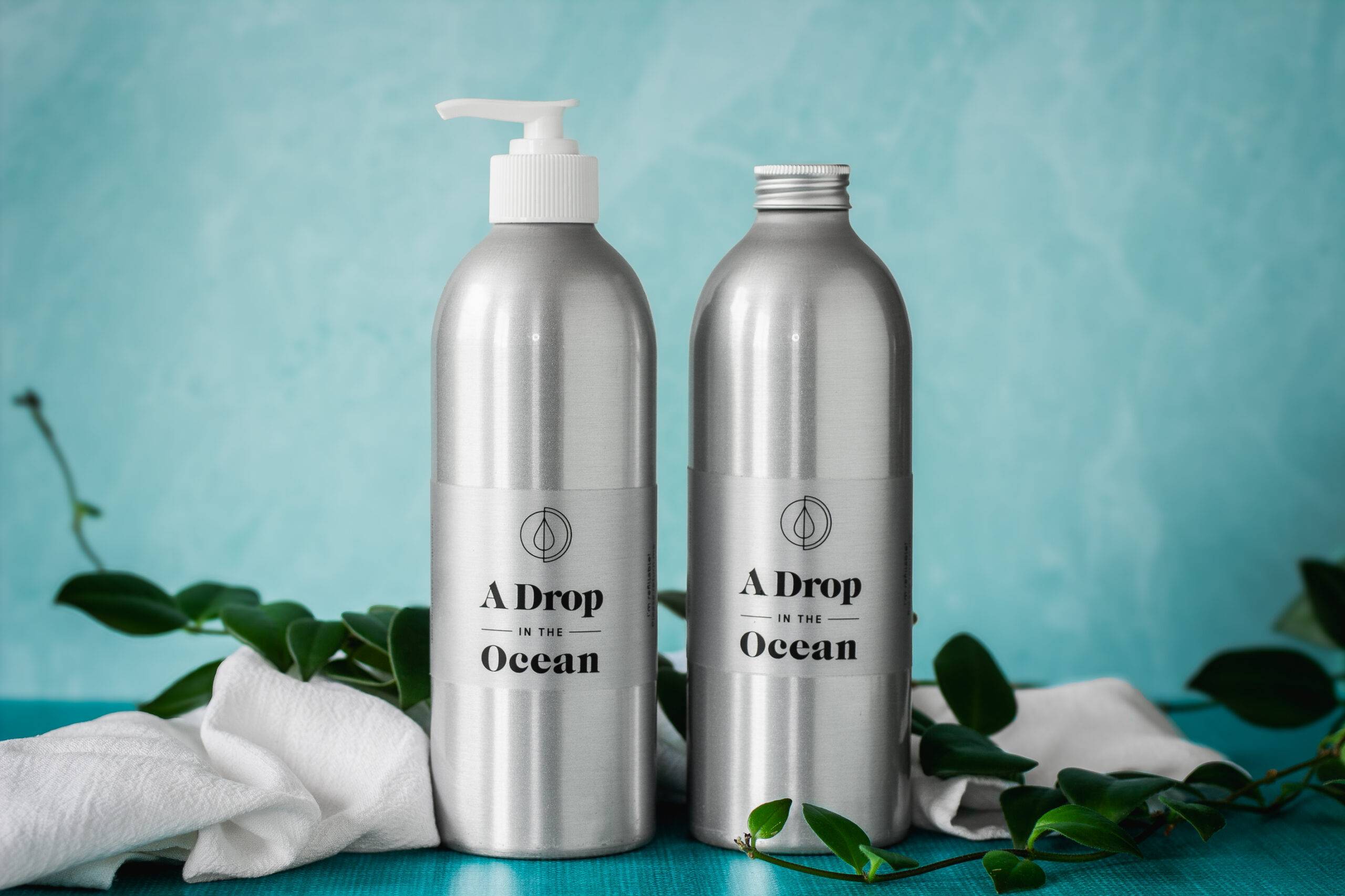 two 16oz refillable aluminum bottles, one with a white lotion pump and one with a metal cap