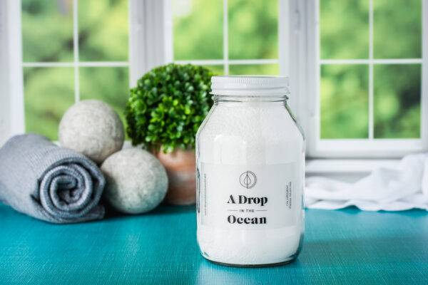 Glass jar filled with refillable, all-natural laundry detergent powder