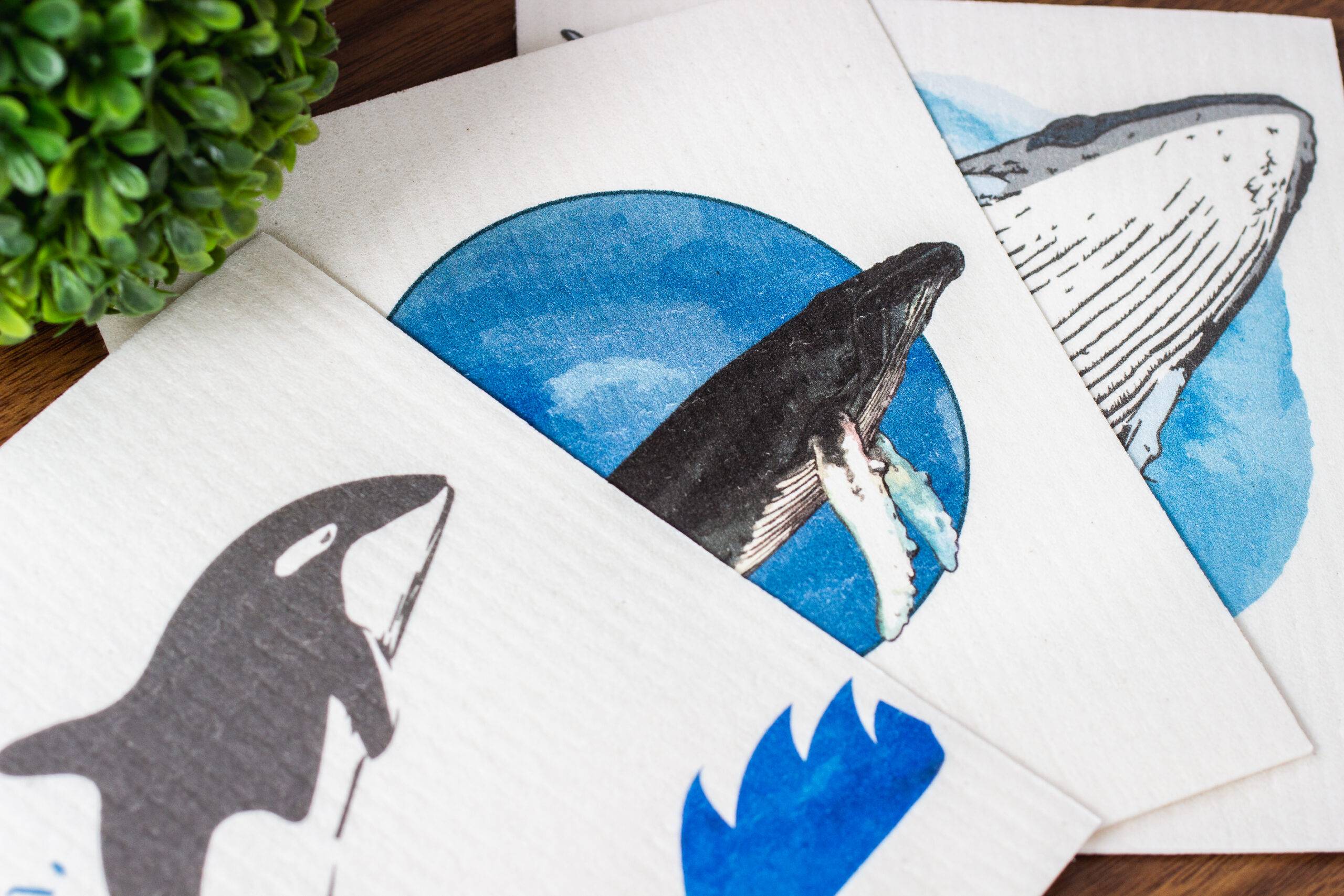 three marine mammal-themed Swedish dishcloths: orca, blue whale, and gray whale designs