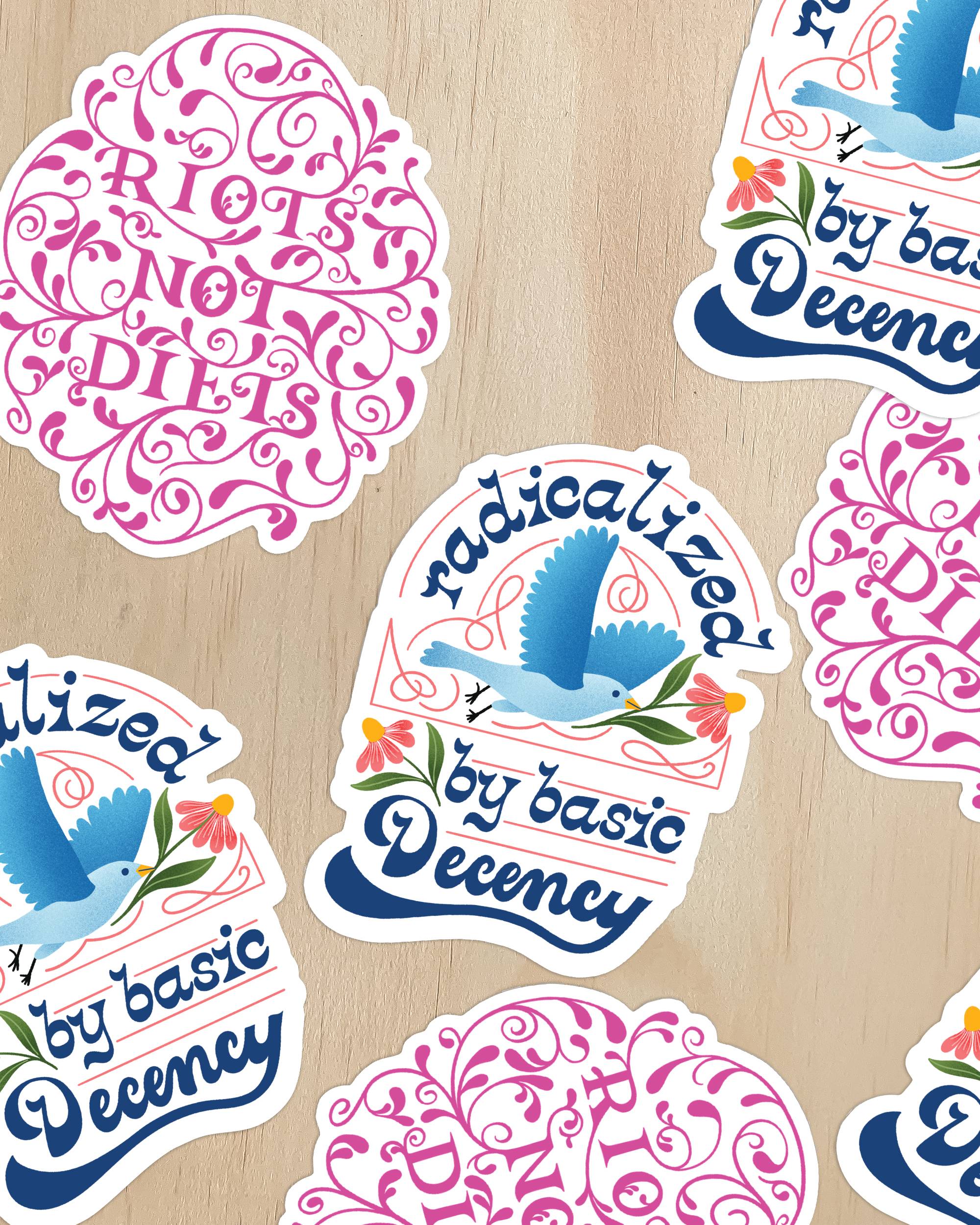 two vinyl sticker designs on a wood background. one sticker is pink with decorative text 