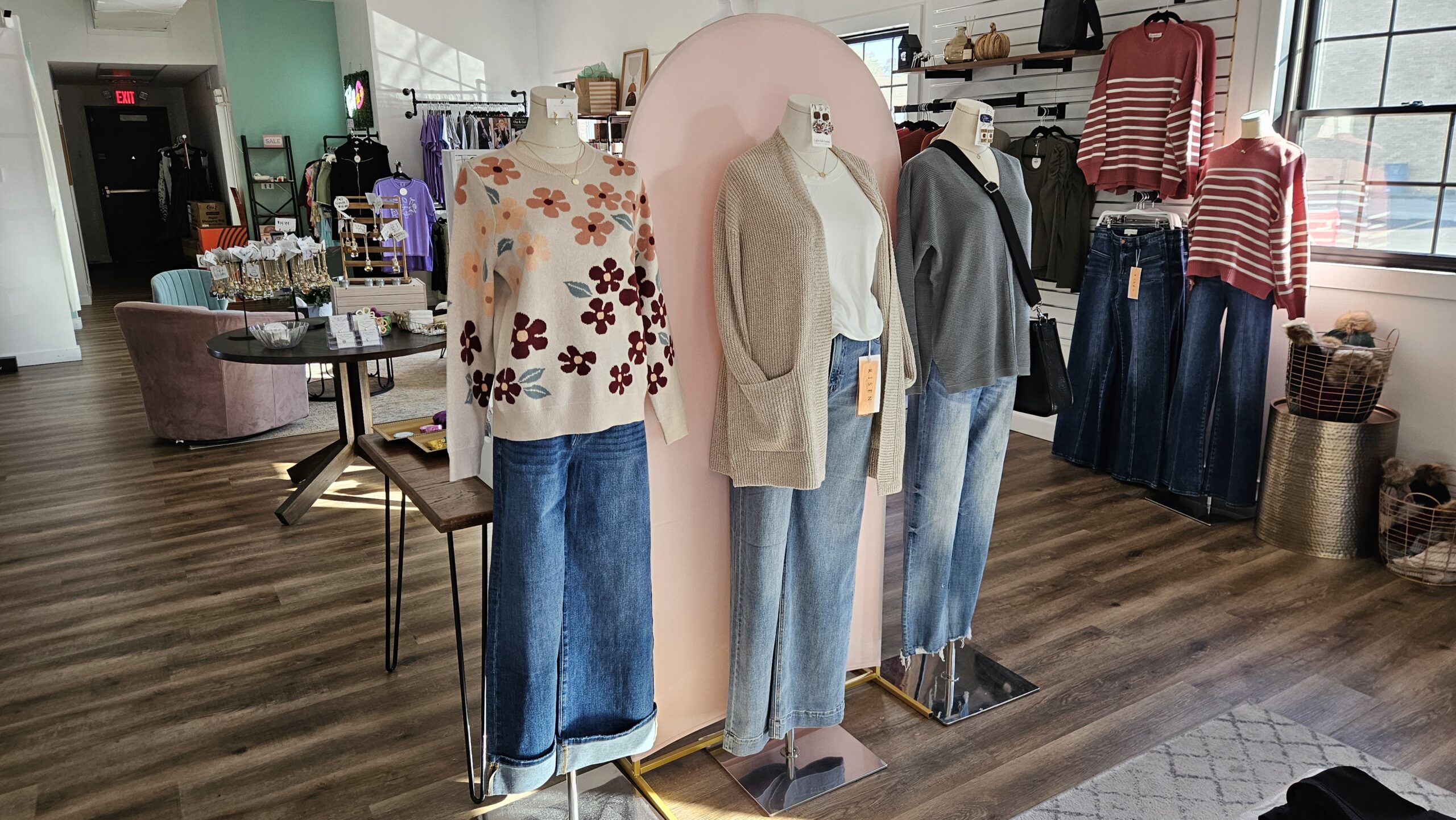 Photo of 3 mannequins in fall outfits, and the interior of Ruby Joy Boutique.