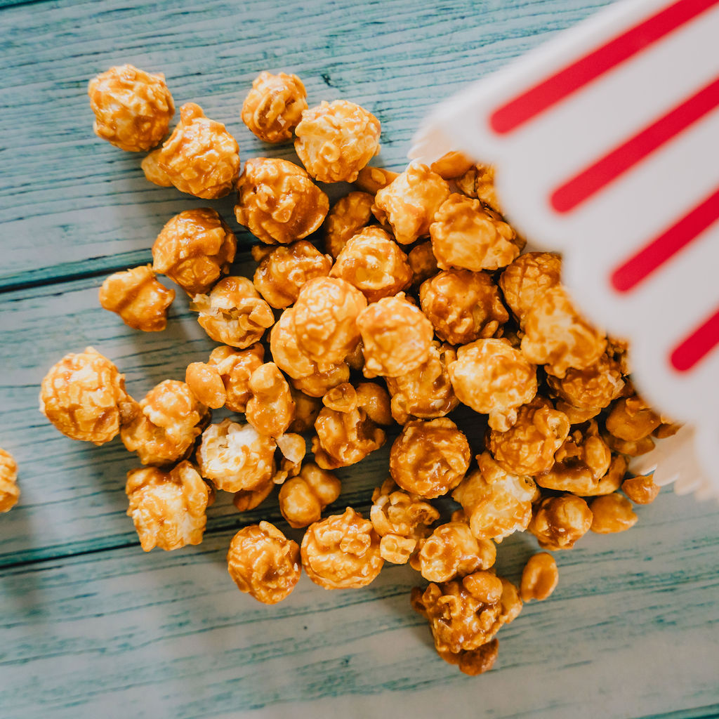 Grand Slam Salted Peanut Caramel Corn spilling out of container
