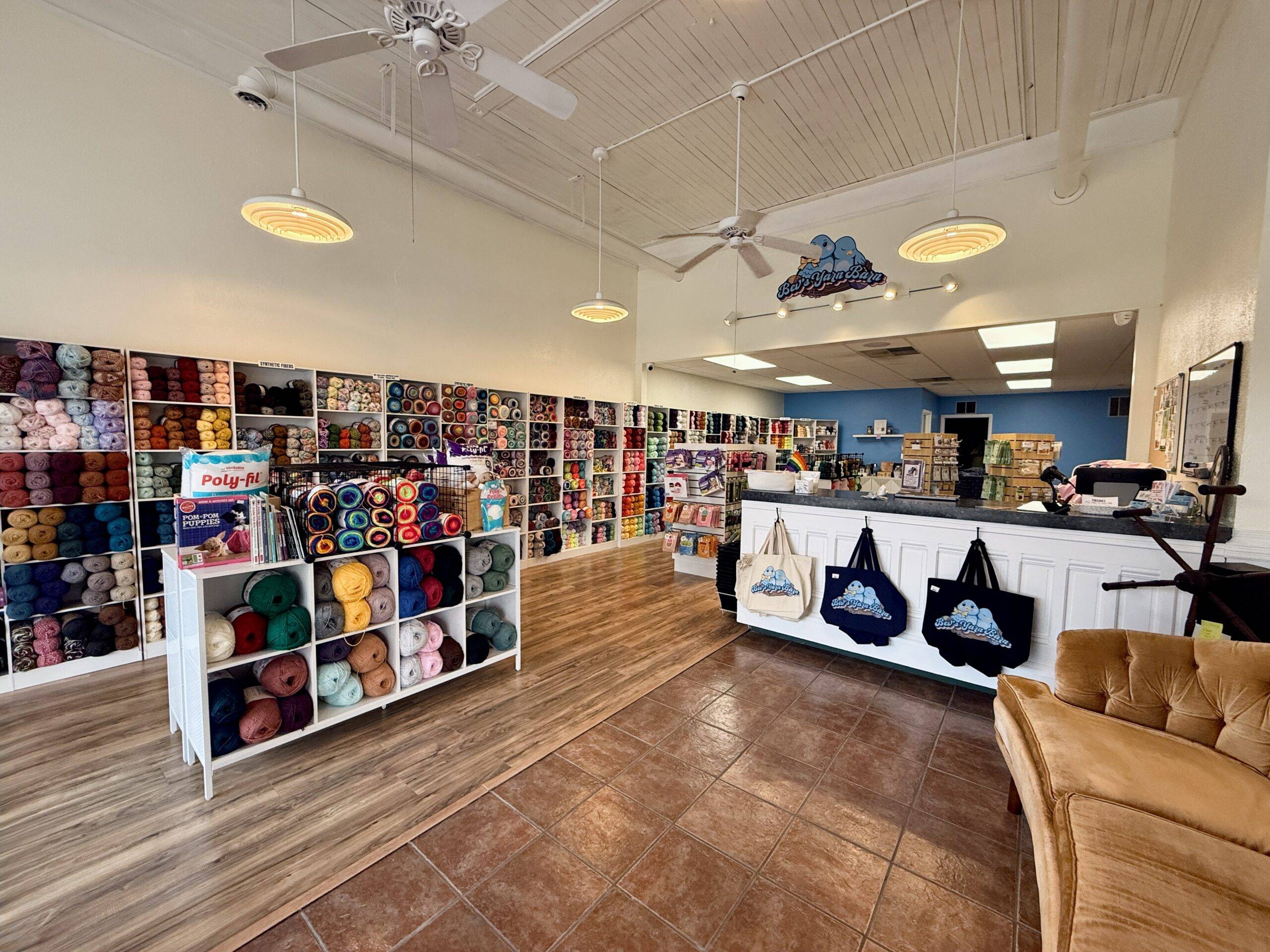 Inside of Bev’s Yarn Barn, displays full of colorful yarn, accessible space