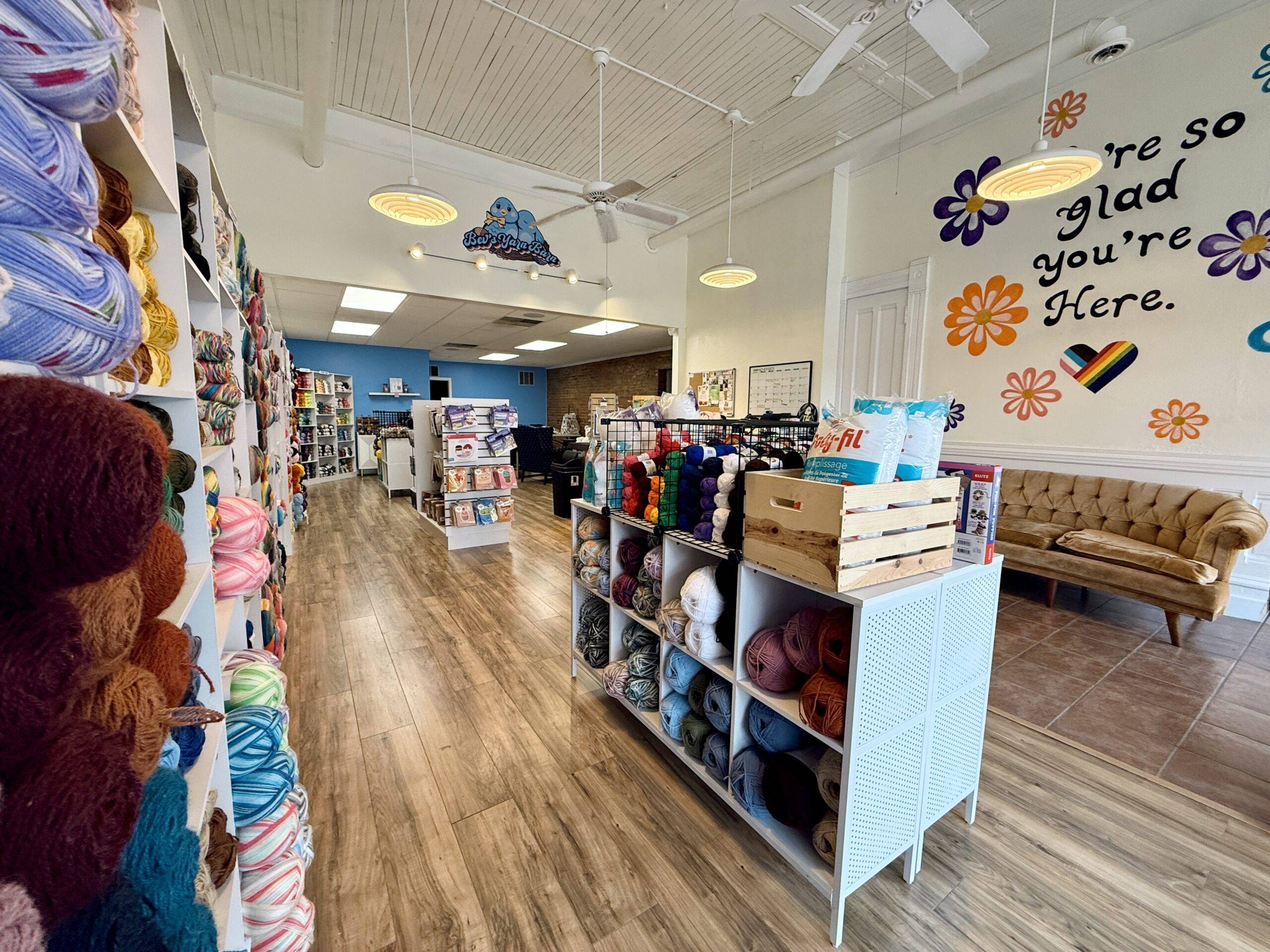 Alternate view of Inside of Bev’s Yarn Barn, displays full of colorful yarn, accessible space