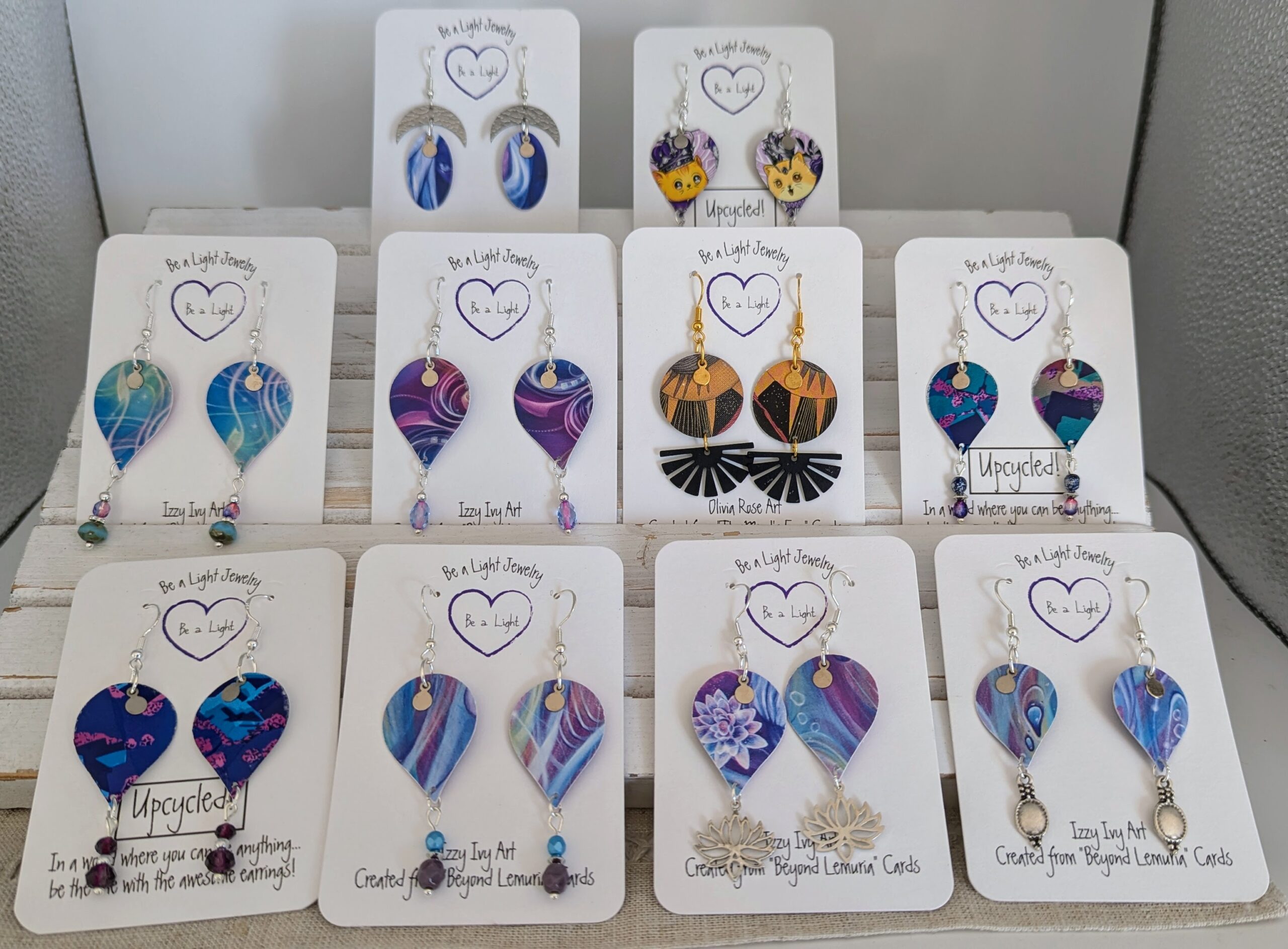 A sample of upcycled earrings created from Tarot cards and other items.