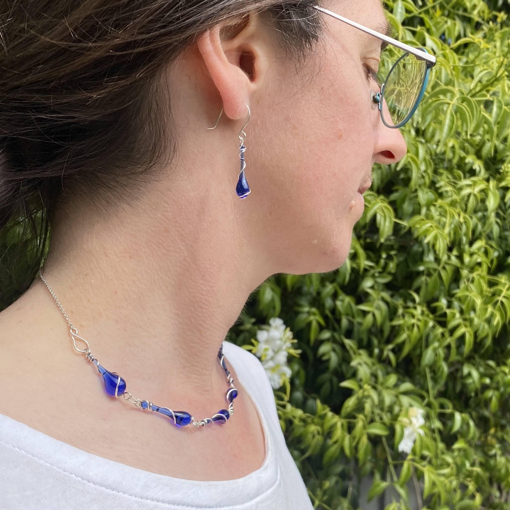 Cobalt blue earrings and necklace made from Skyy Vodka bottles melted with sunshine and a giant magnifying glass.