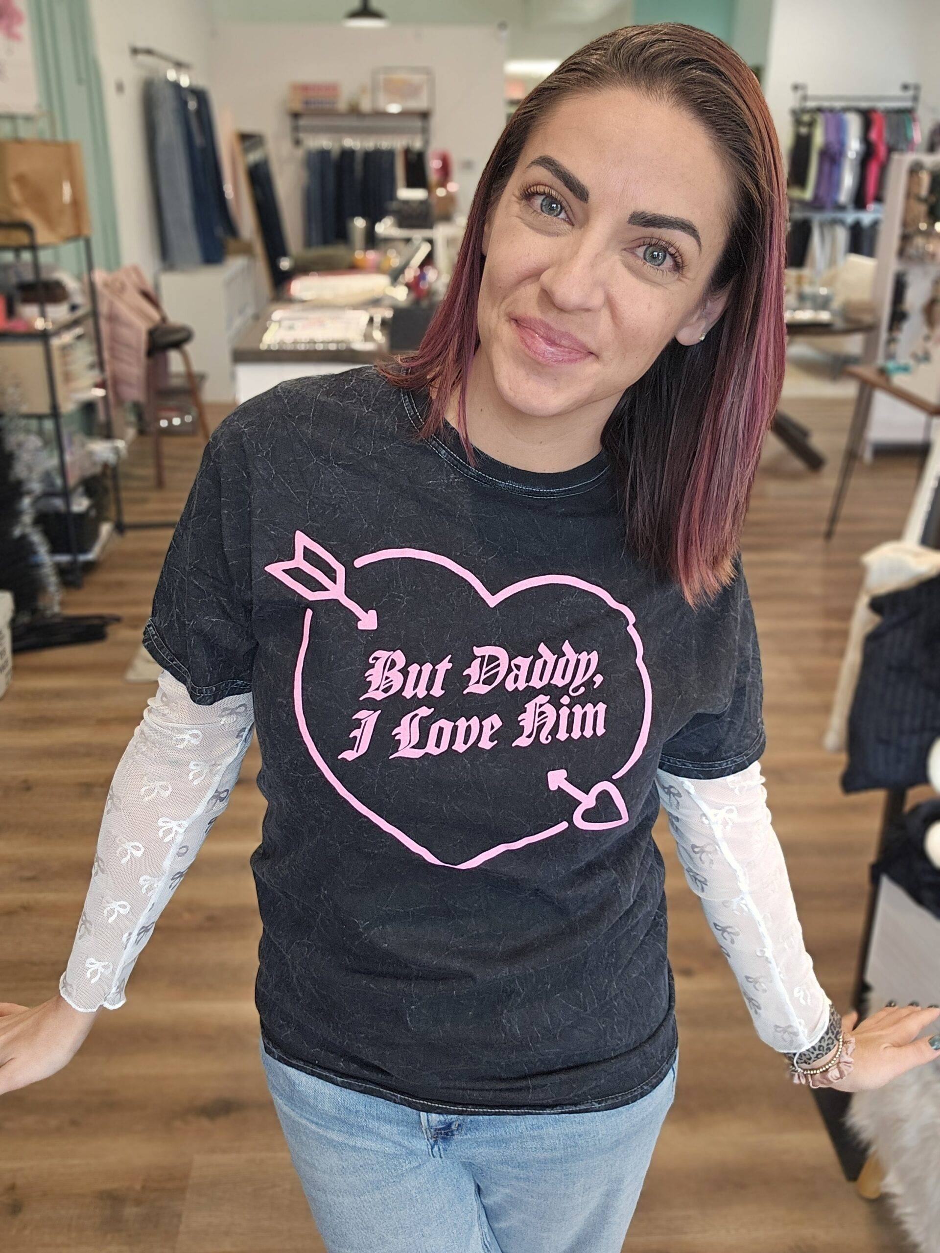 Woman wearing a black mineral washed tee shirt that reads 