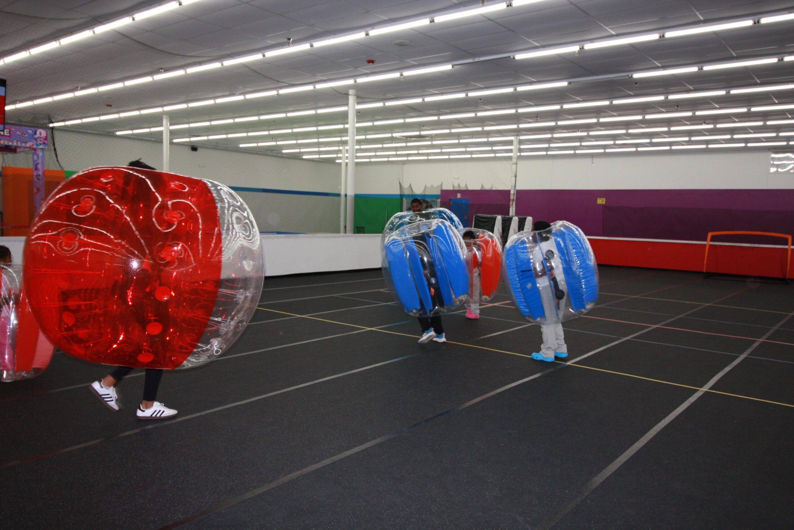 Kids and adults playing Bubble Soccer