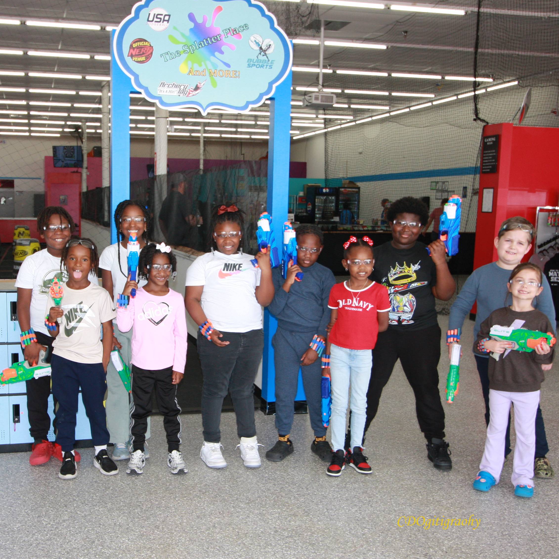 Group of kids with Nerf guns posing for a picture