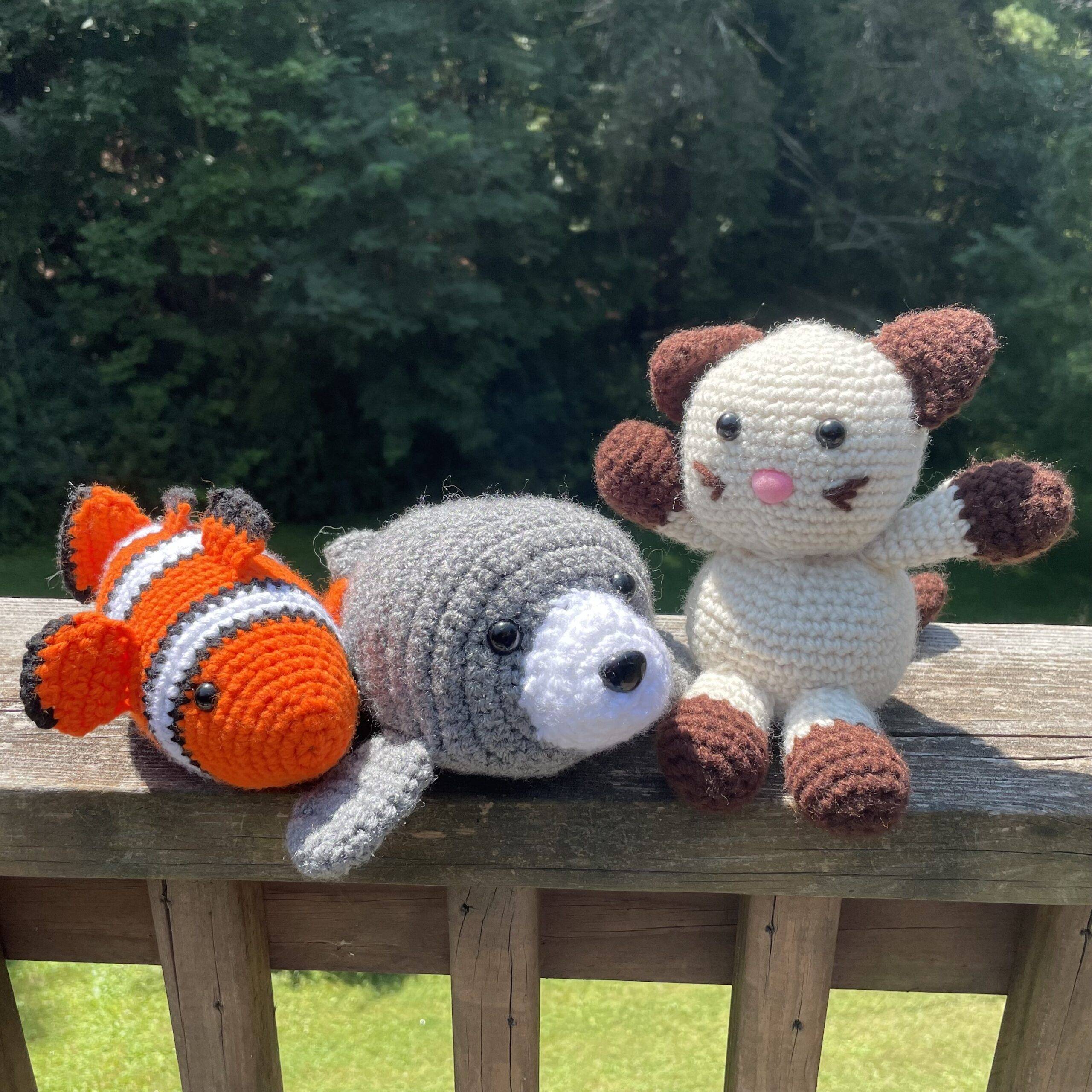 Crocheted items including clownfish, seal, and Siamese cat.