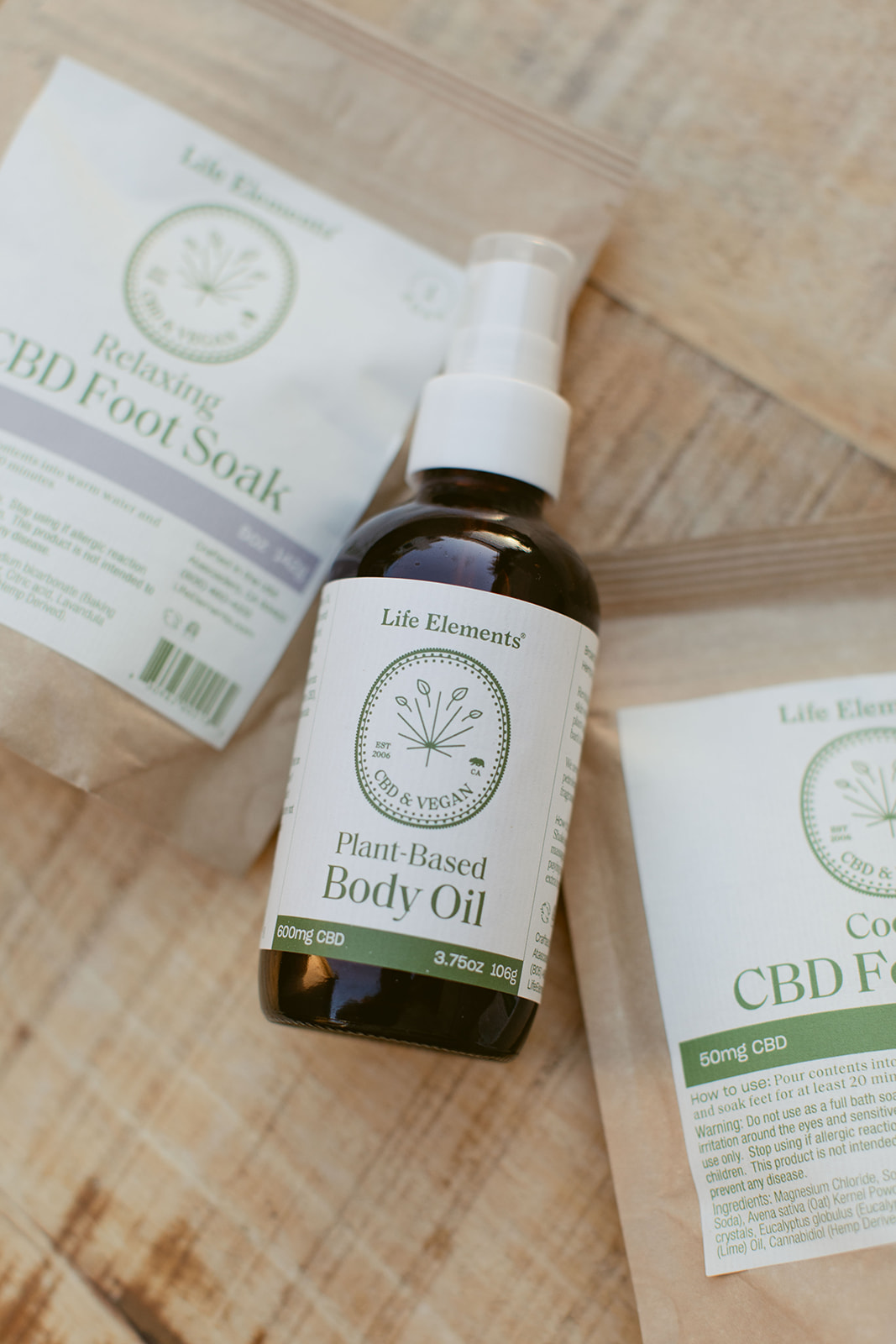 Bags of CBD Foot Soak Salts and CBD Body Oil