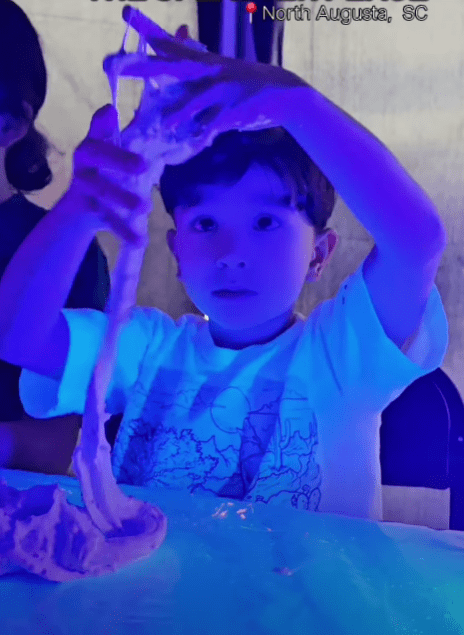 Boy making glow-in-the-dark slime