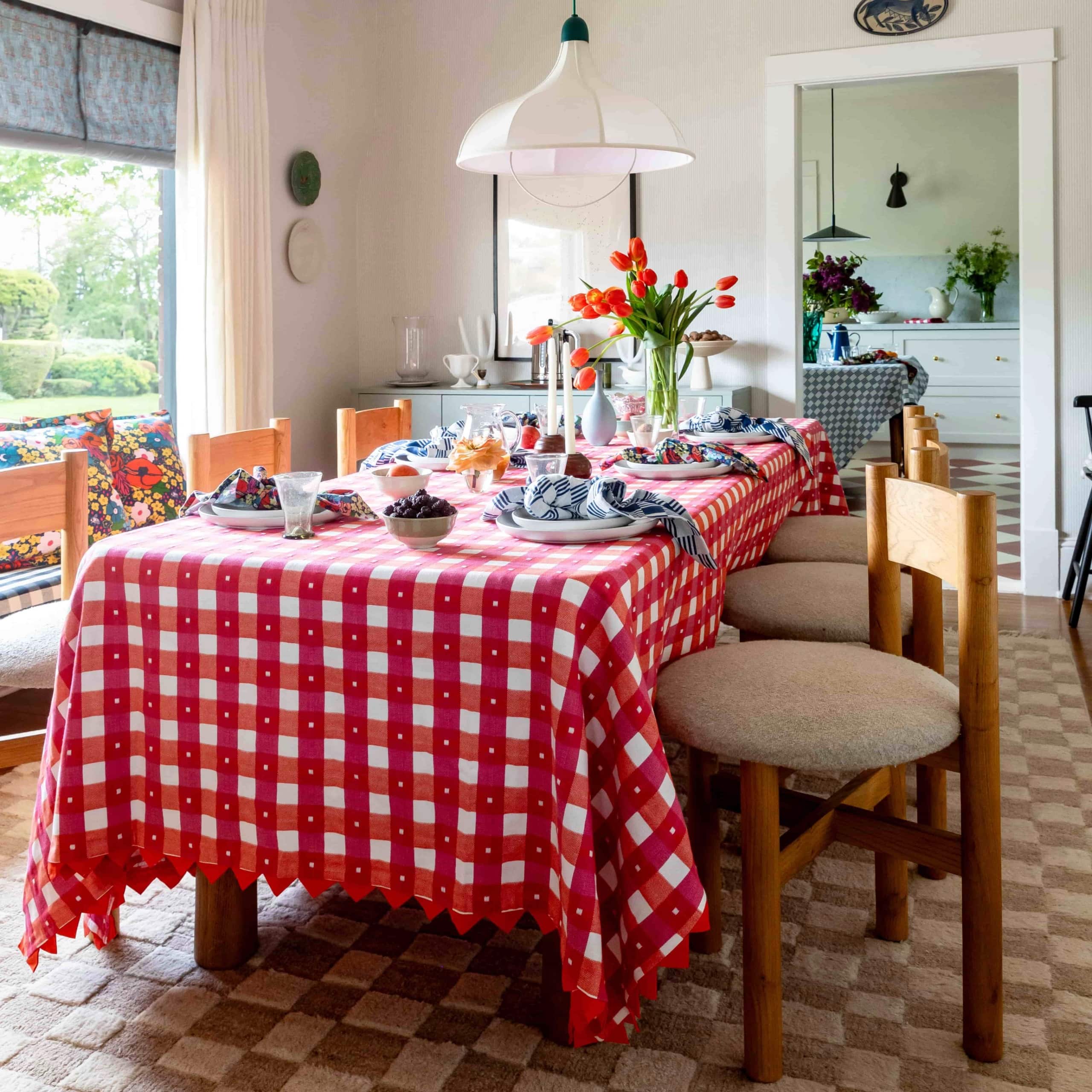 A photo of a table set with a cheerful gingham tablecloth with quilt point edges.