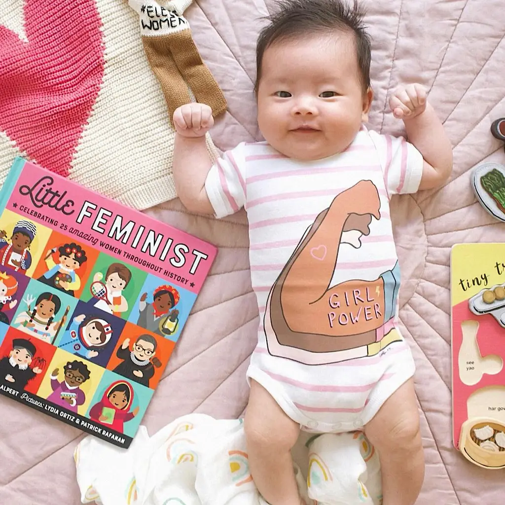 Baby in pink stripe girl power organic cotton bodysuit