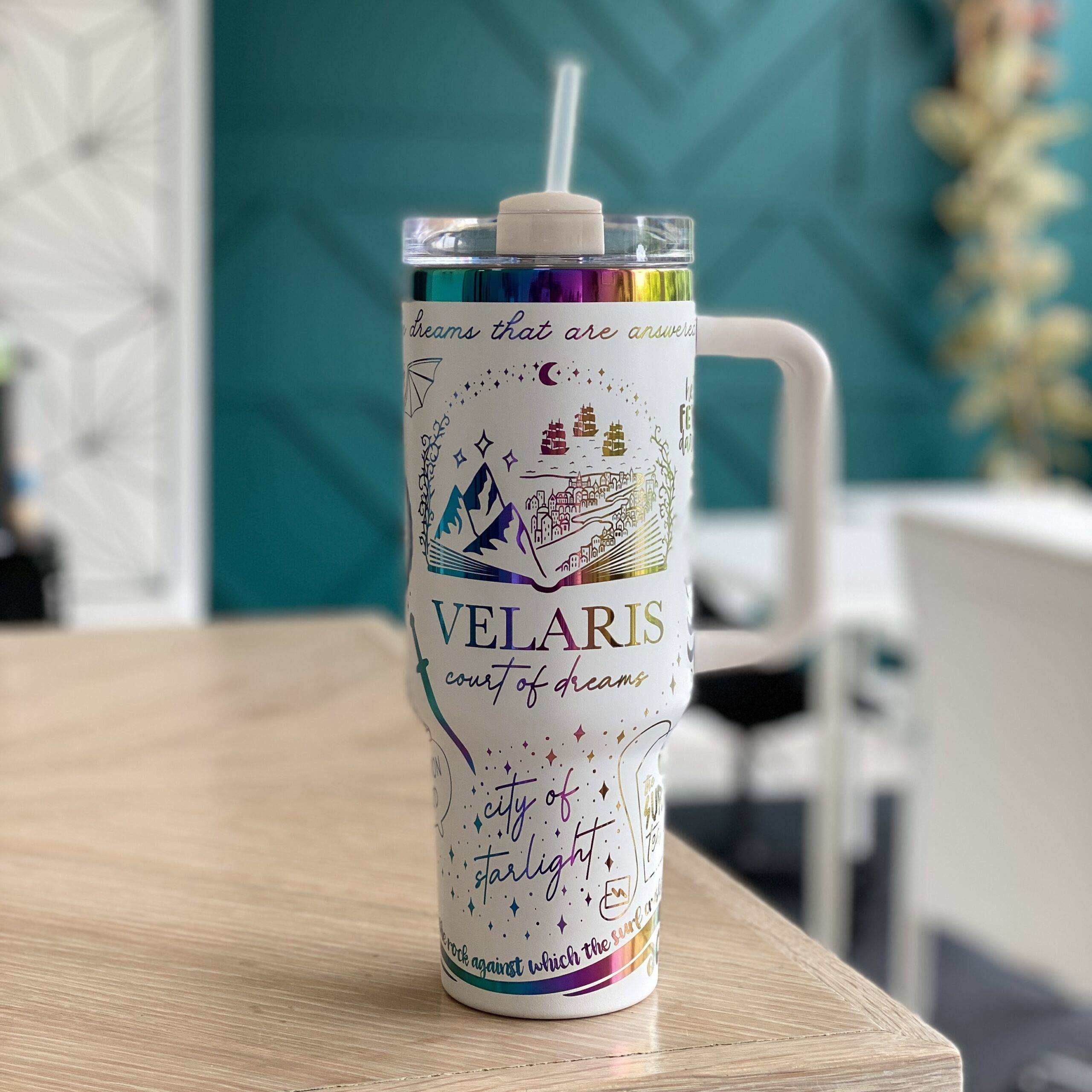 Engraved tumbler with ACOTAR design by zoo&roo on a wood table.