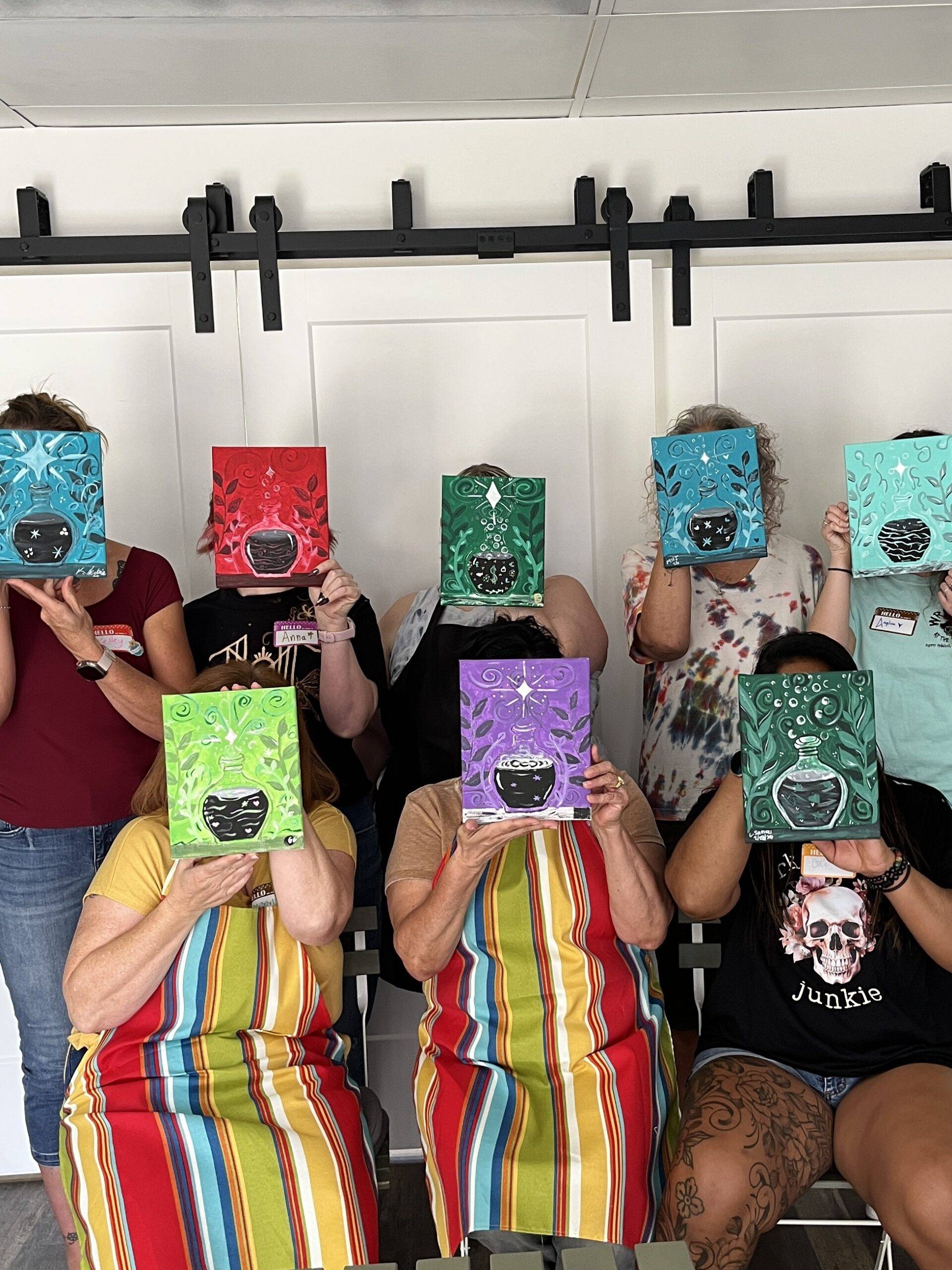 group photo of Painting Friends Studio painters with paintings